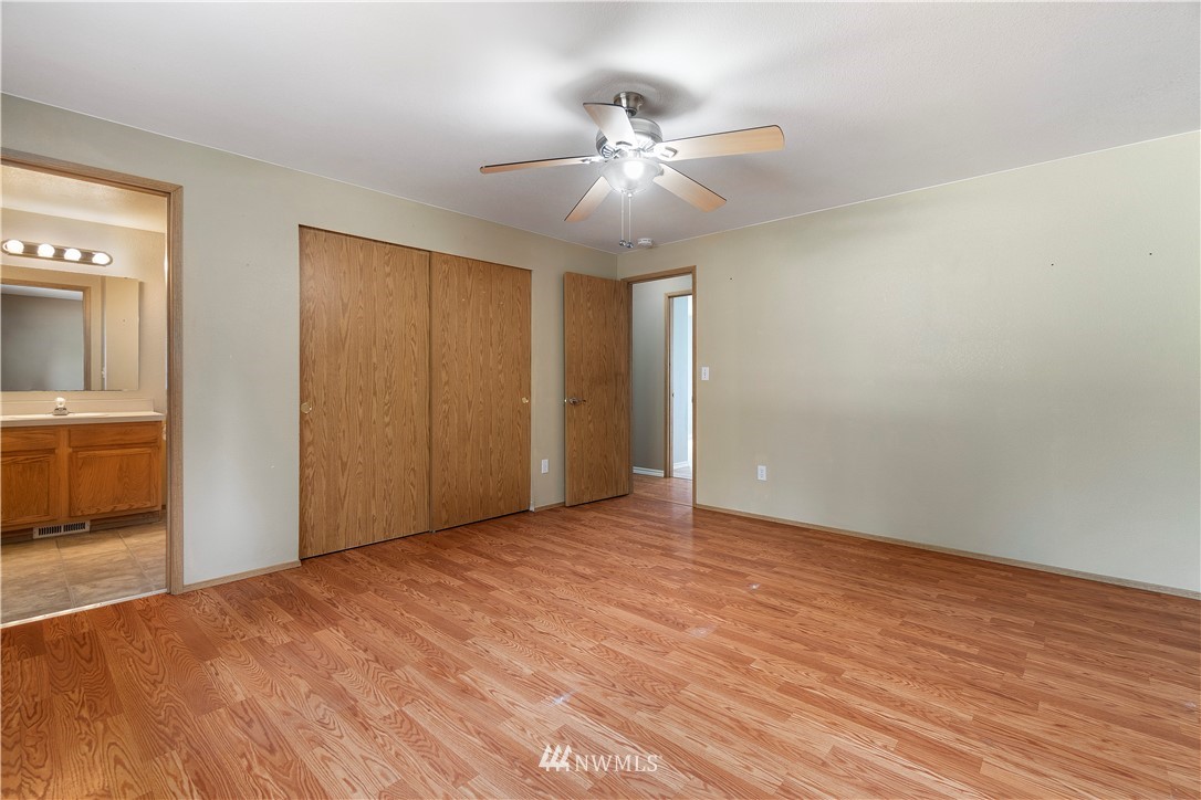 5418 187th Court Southwest Rochester, WA 98579 - Photo 10 of 24 a view of an empty room with a chandelier fan