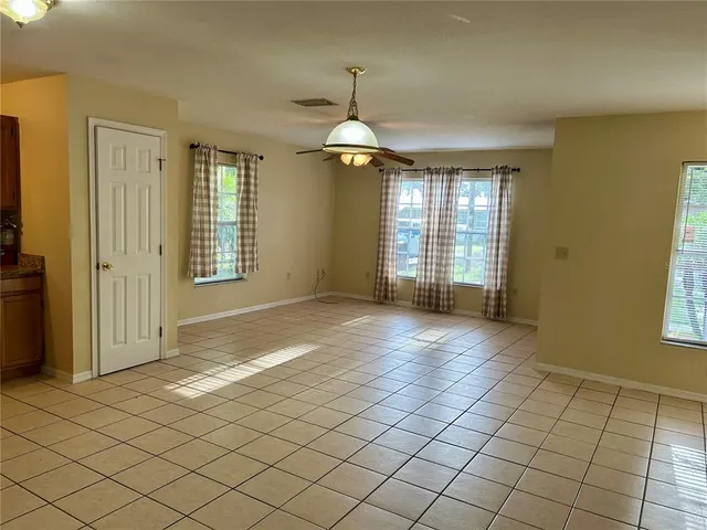 an empty room with windows and entrance