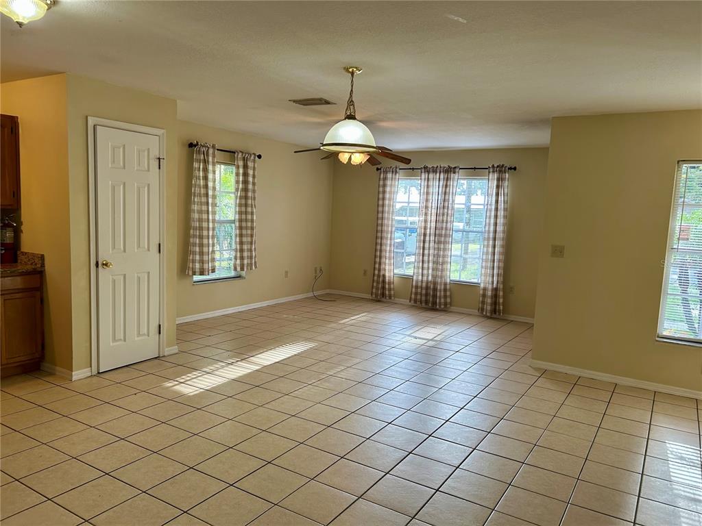 209 1st Avenue Wauchula, FL 33873 - Photo 12 of 27 an empty room with windows and entrance