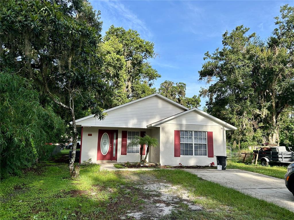 209 1st Avenue Wauchula, FL 33873 - Photo 2 of 27 a view of a house with a yard porch and sitting area