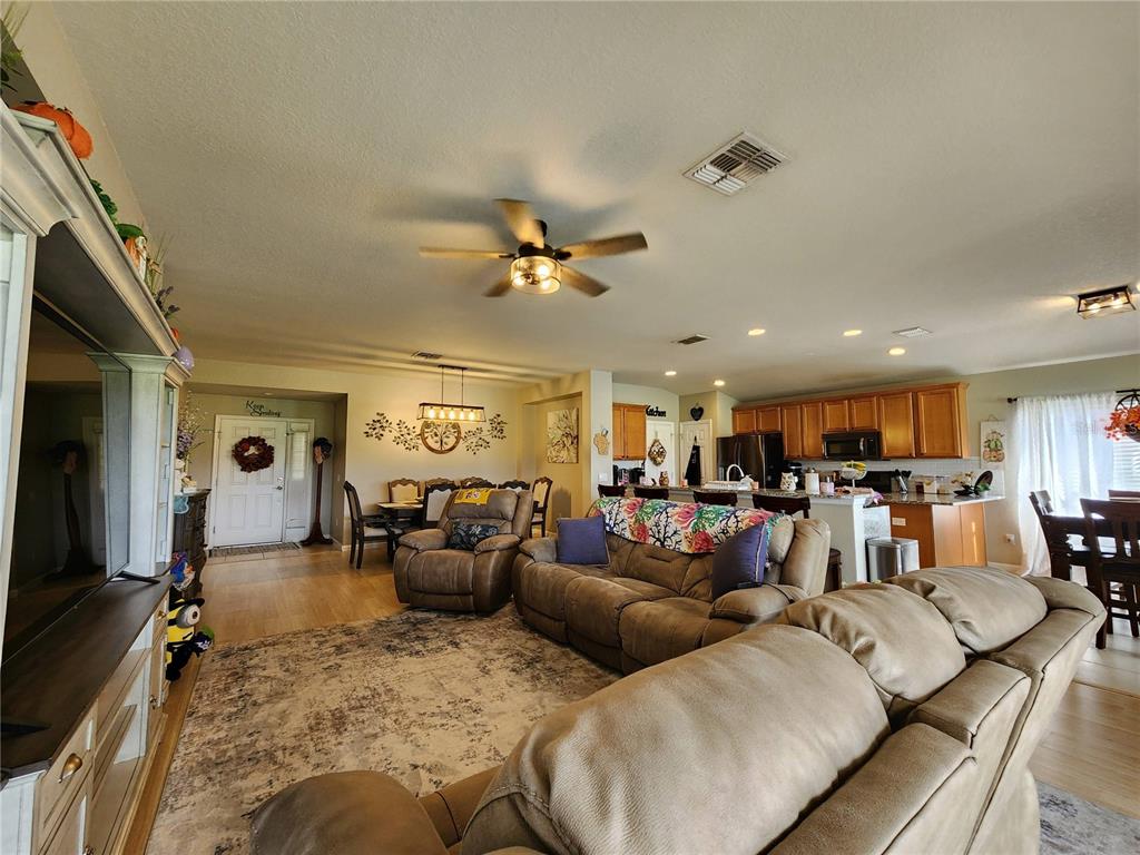 4740 Southwest 41st Street Ocala, FL 34474 - Photo 11 of 31 a living room with furniture kitchen view and a large window