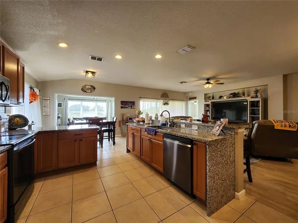 a kitchen with stainless steel appliances granite countertop a sink and cabinets