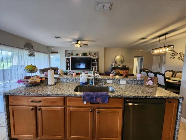 a kitchen with sink a stove and cabinets