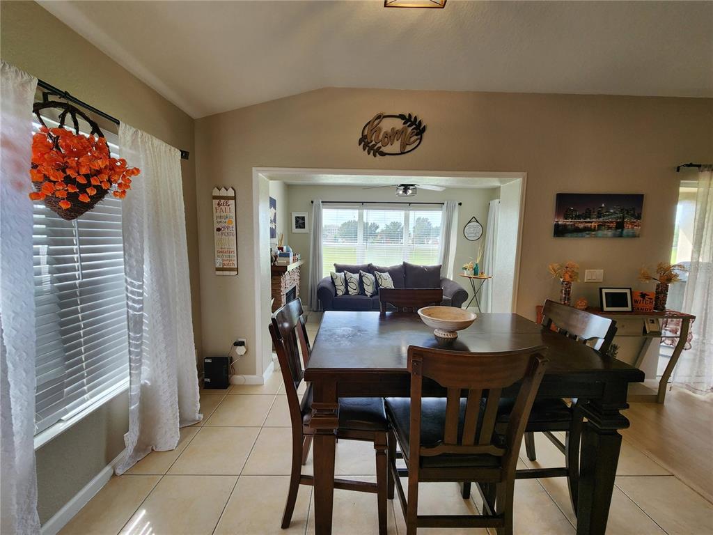 4740 Southwest 41st Street Ocala, FL 34474 - Photo 17 of 31 a view of a dining room with furniture and wooden floor