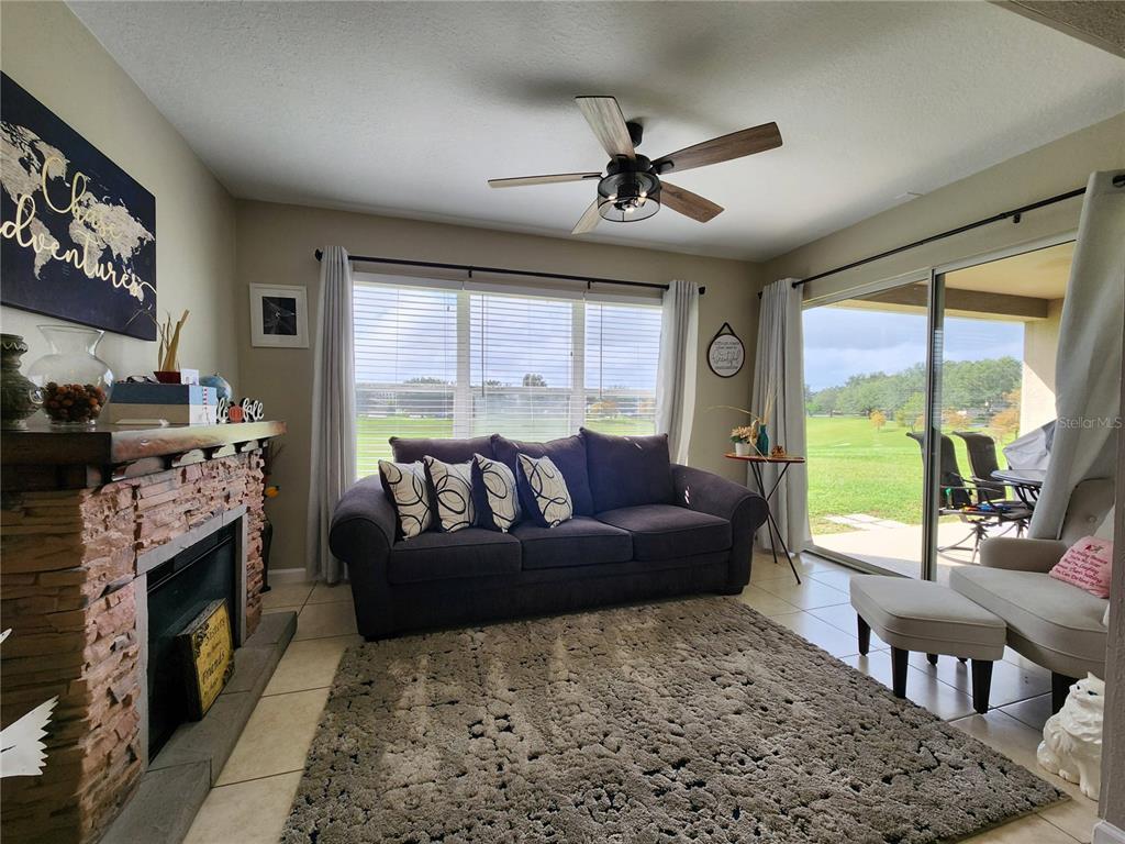 4740 Southwest 41st Street Ocala, FL 34474 - Photo 18 of 31 a living room with furniture fireplace and a large window