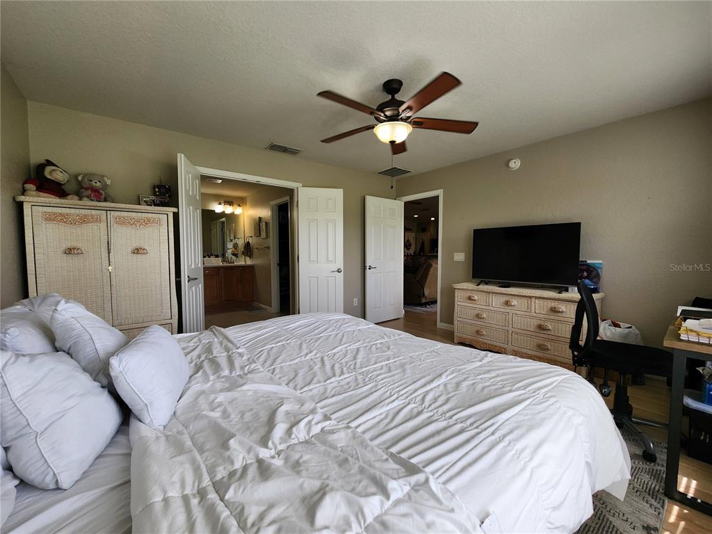 4740 Southwest 41st Street Ocala, FL 34474 - Photo 22 of 31 a bedroom with a bed and a flat screen tv