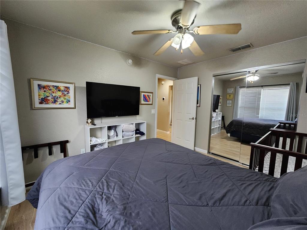 4740 Southwest 41st Street Ocala, FL 34474 - Photo 27 of 31 a bedroom with a bed and a flat screen tv