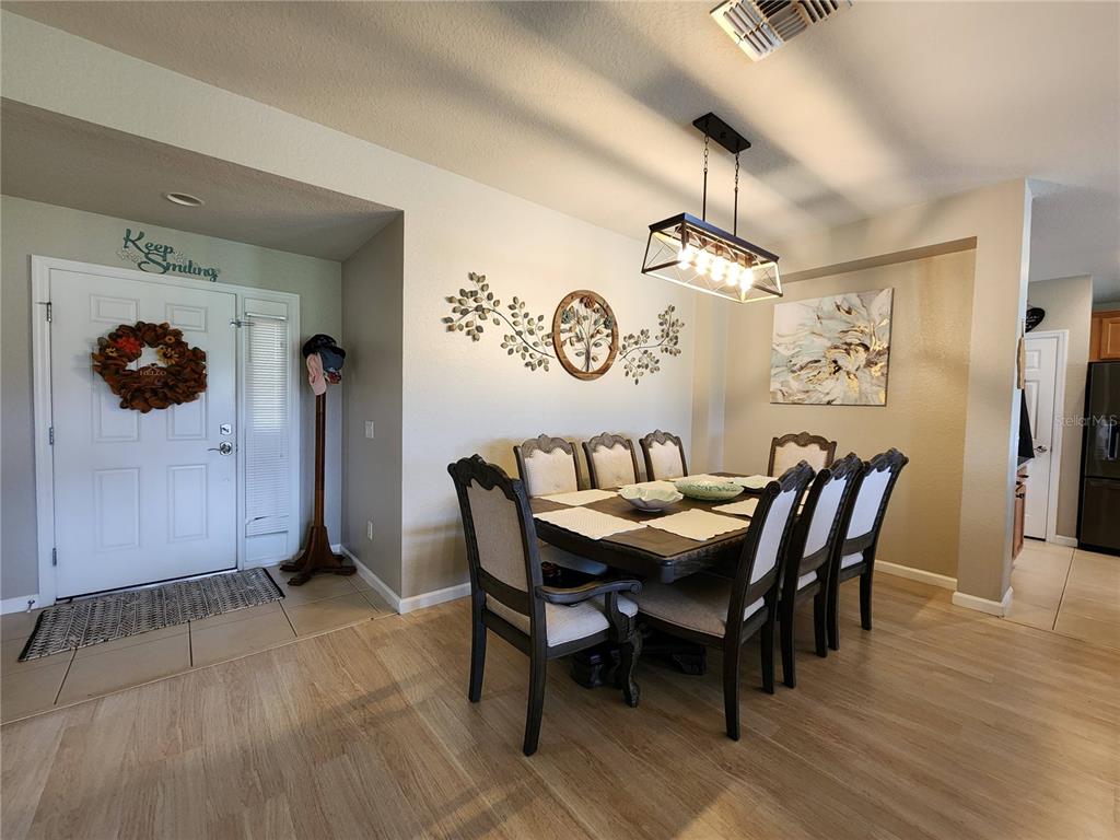 4740 Southwest 41st Street Ocala, FL 34474 - Photo 10 of 31 a view of a dining room with furniture and wooden floor