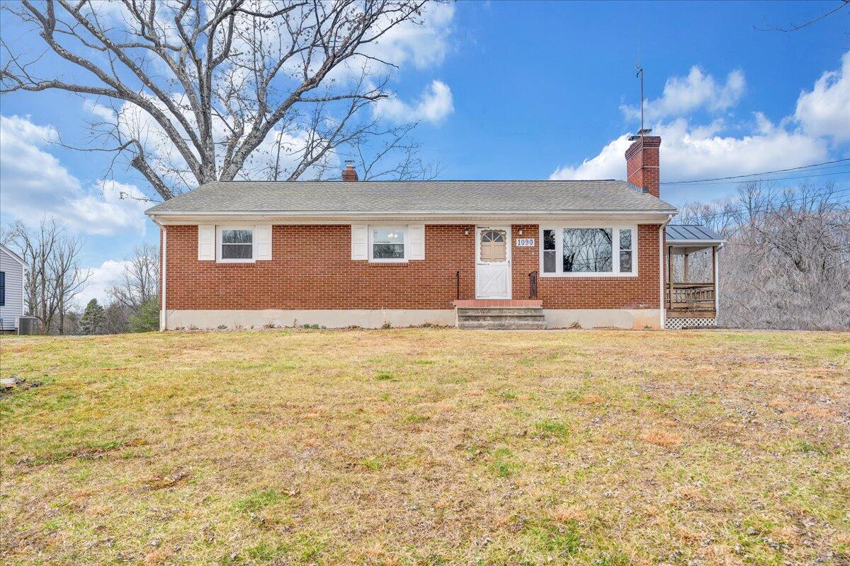 1090 Garner Road Vinton, VA 24179 - Photo 1 of 23 a front view of house with yard and trees in the background