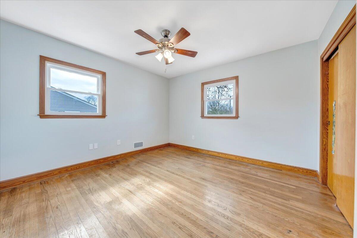 1090 Garner Road Vinton, VA 24179 - Photo 12 of 23 a view of an empty room with wooden floor and a window