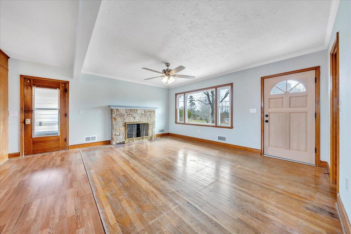 1090 Garner Road Vinton, VA 24179 - Photo 3 of 23 an empty room with wooden floor and windows