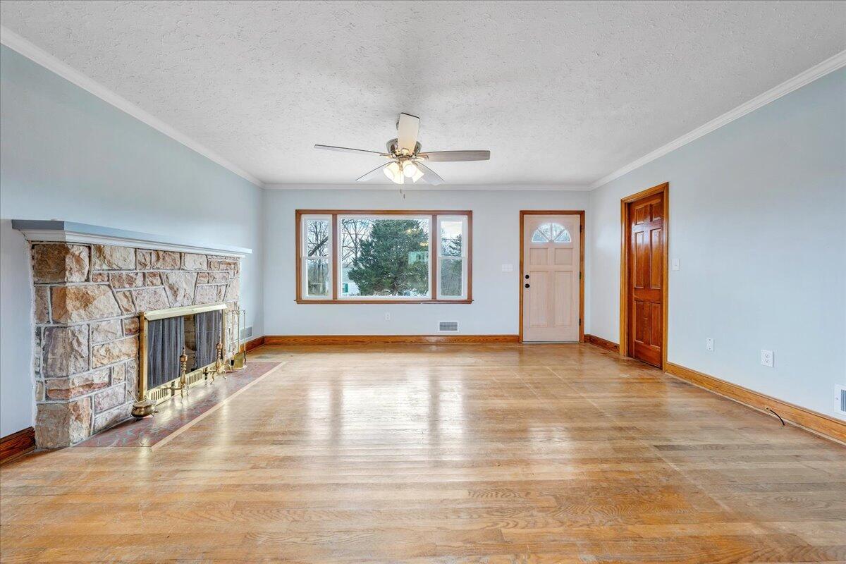 1090 Garner Road Vinton, VA 24179 - Photo 4 of 23 wooden floor fireplace and windows in an empty room