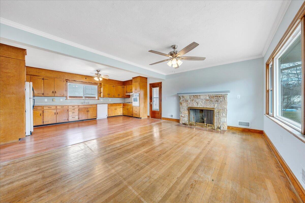 1090 Garner Road Vinton, VA 24179 - Photo 5 of 23 an empty room with a fireplace and windows