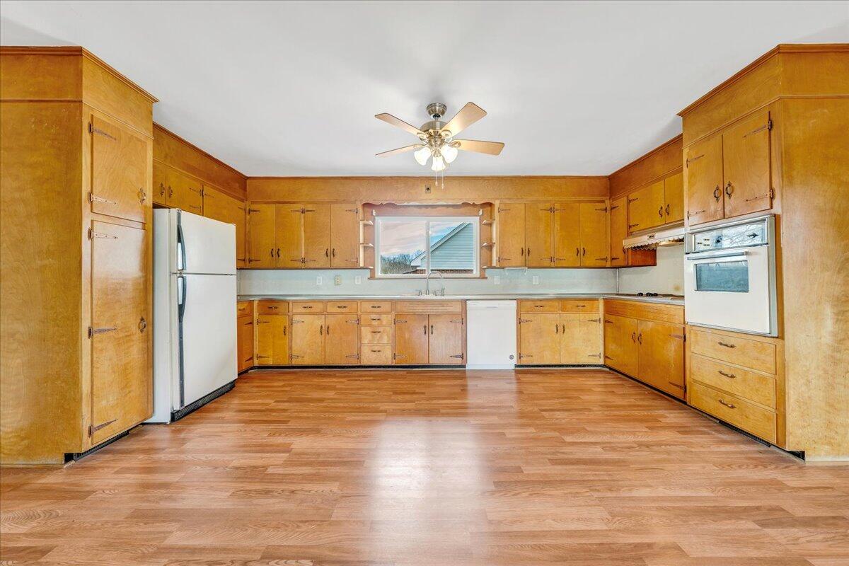 1090 Garner Road Vinton, VA 24179 - Photo 7 of 23 a large kitchen with cabinets and wooden floor