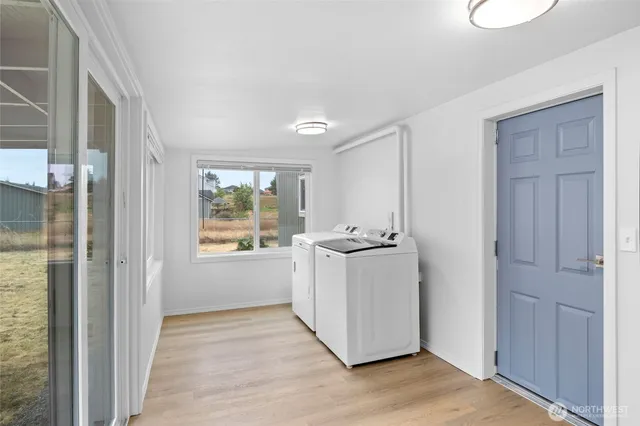 a view of a kitchen with wooden floor and electronic appliances