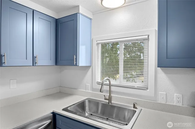 a kitchen with a sink and a window