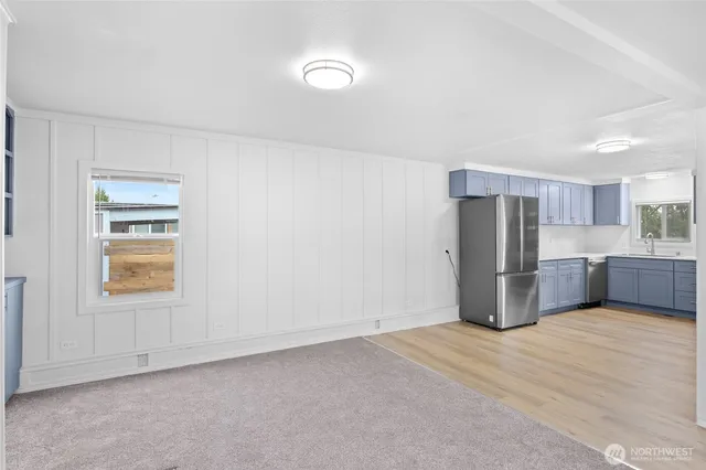 a view of an empty room with a kitchen