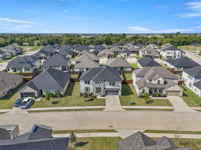 an aerial view of residential houses with outdoor space