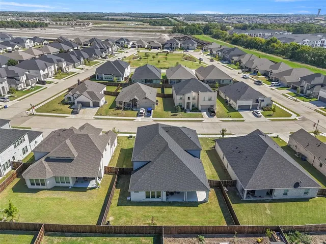 an aerial view of residential houses with outdoor space