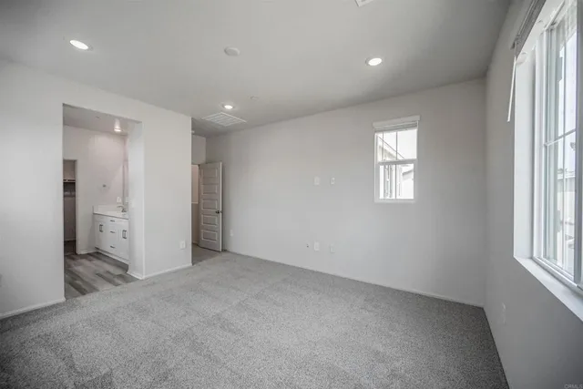 an empty room with windows and closet