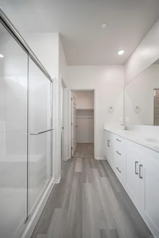 a bathroom with a double vanity sink and mirror