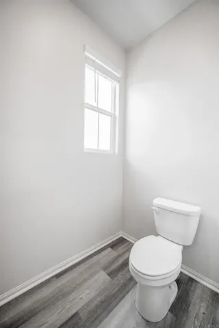 a white toilet sitting next to a window
