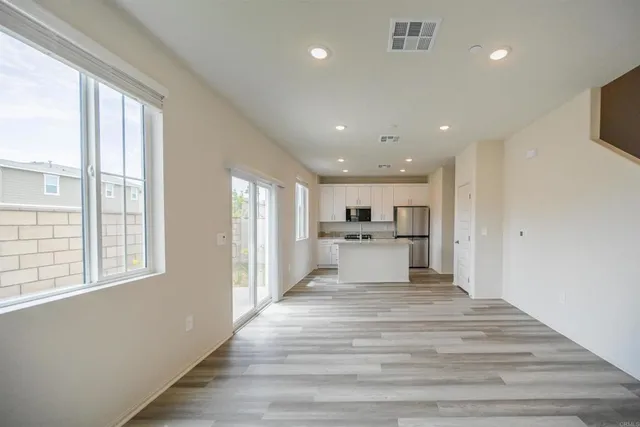 a view of kitchen with sink and refrigerator