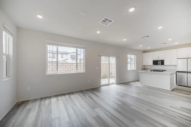 a view of kitchen with sink and wooden floor