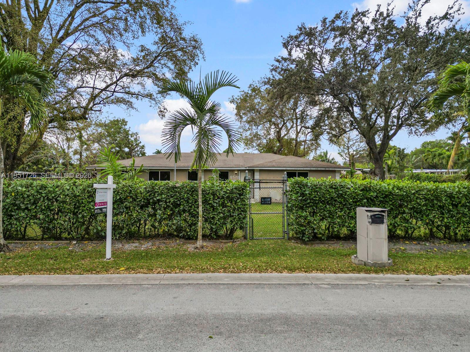 a view of a house with a yard and plants