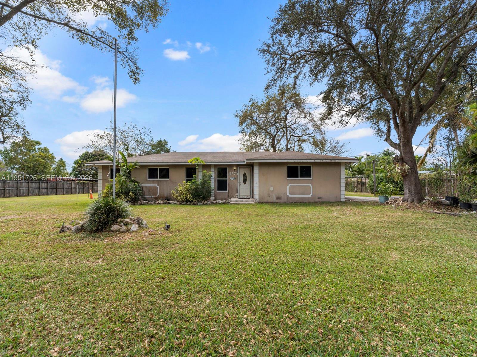 12570 Southwest 45th Street Miami, FL 33175 - Photo 12 of 25 a view of a house with a backyard and a tree