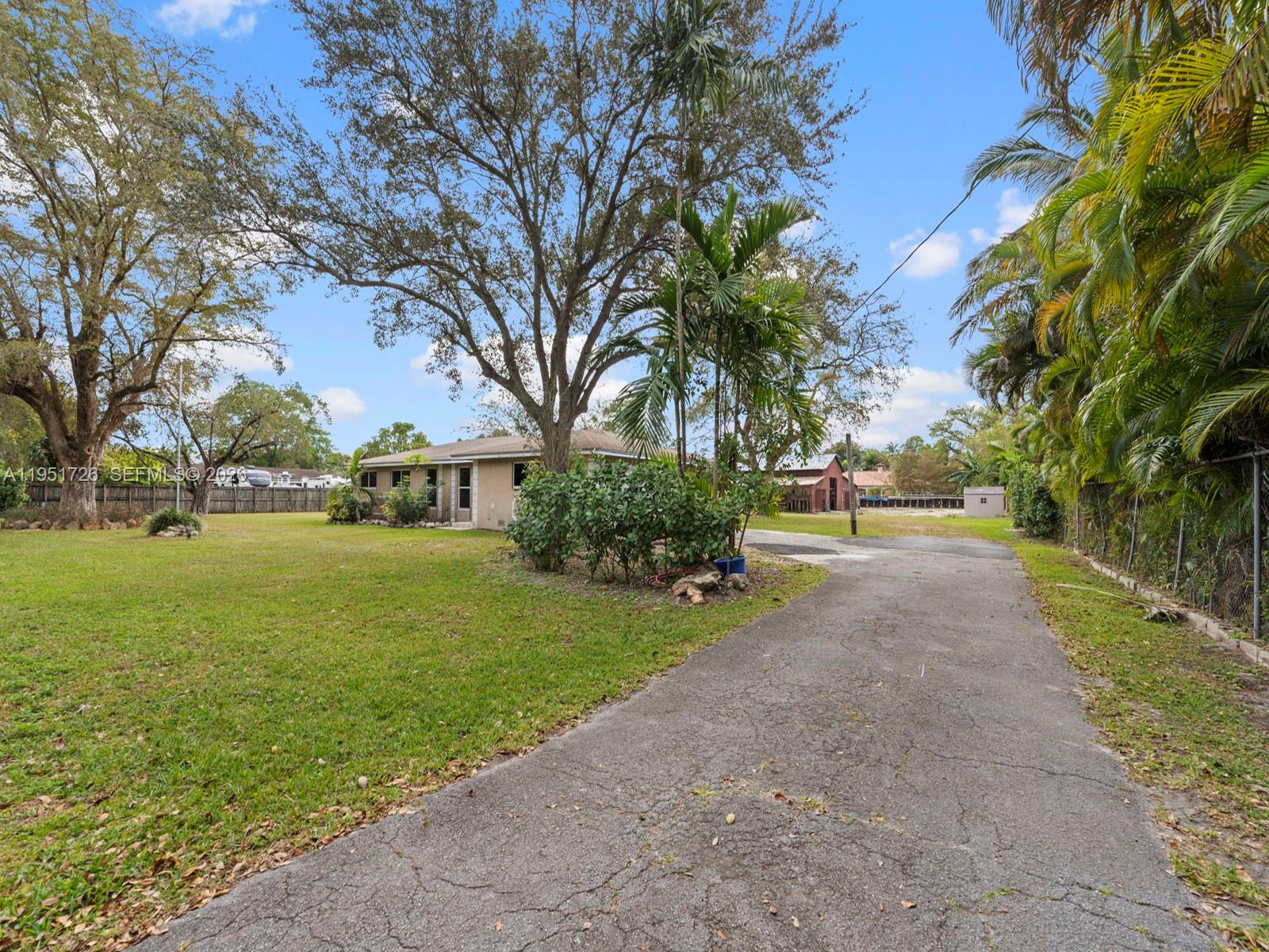 12570 Southwest 45th Street Miami, FL 33175 - Photo 13 of 25 a view of a house with garden and trees
