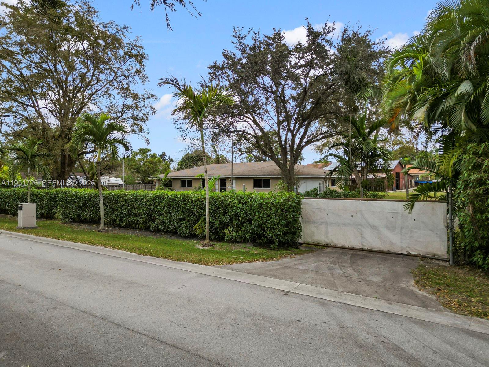 12570 Southwest 45th Street Miami, FL 33175 - Photo 10 of 25 a view of a yard with plants and large trees