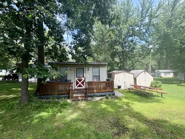 a view of backyard with seating area and green space