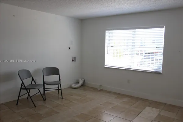 a view of a room that has a window and chair