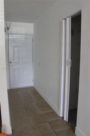 a view of an empty room and a window