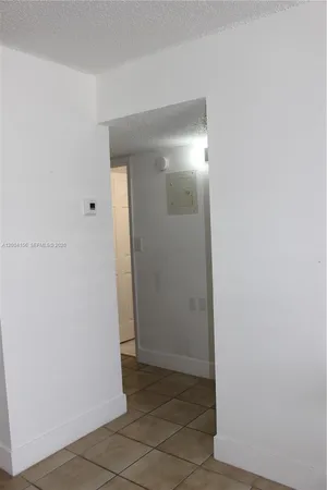 an empty room with wooden floor and a window