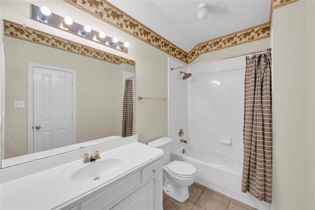 3920 Autumn Lane Bedford, TX 76021 - Photo 29 of 36 Bathroom featuring a white vanity with integrated sink, a large wall-mounted mirror, and tile flooring