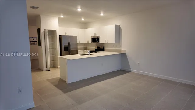 a kitchen with stainless steel appliances a sink stove and refrigerator
