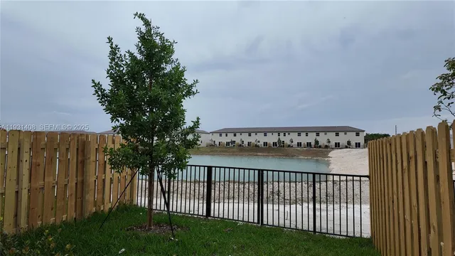 a view of a pathway with a garden