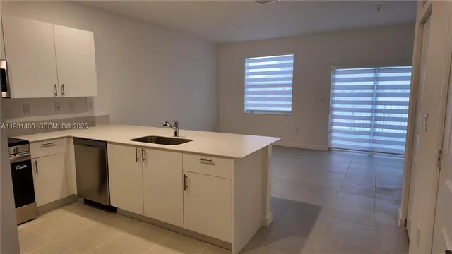 a utility room with a sink washer and dryer