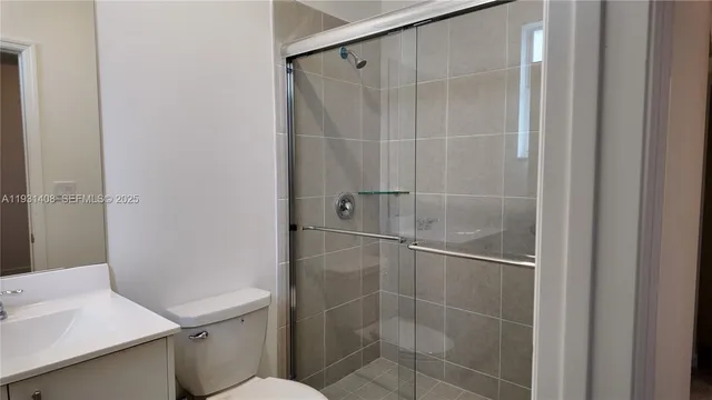 a bathroom with a shower toilet and sink