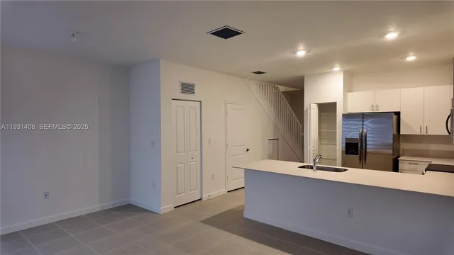 a bathroom with double vanity sink and mirror