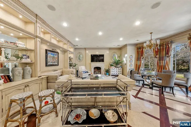 a living room with fireplace furniture and a large window