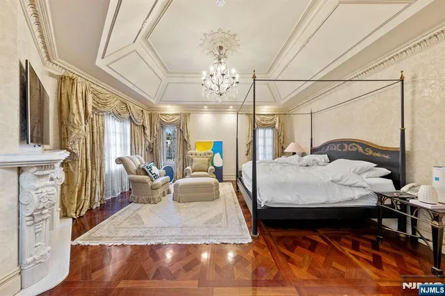 a bedroom with a bed window and a chandelier