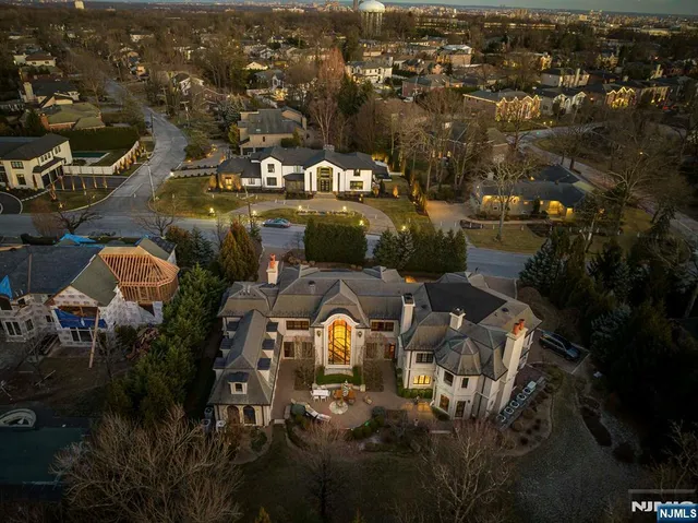 an aerial view of a house with yard swimming pool and lake view