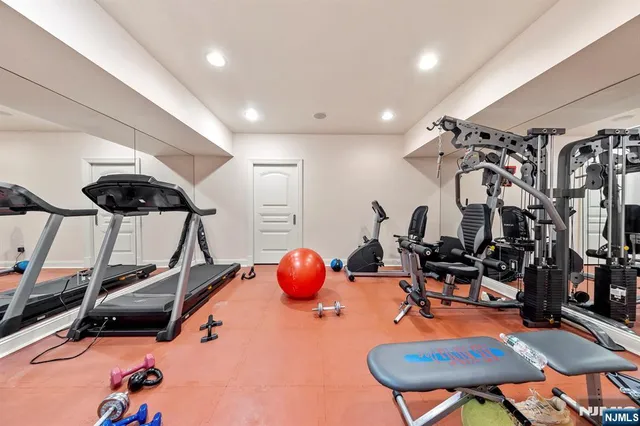 a room with gym equipment and mirror