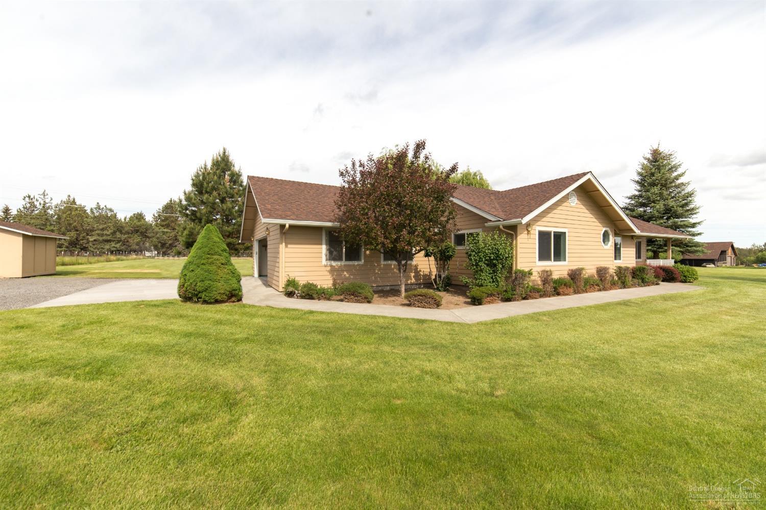 64485 Research Road Bend, OR 97703 - Photo 2 of 18 a view of a house with a yard and a garden