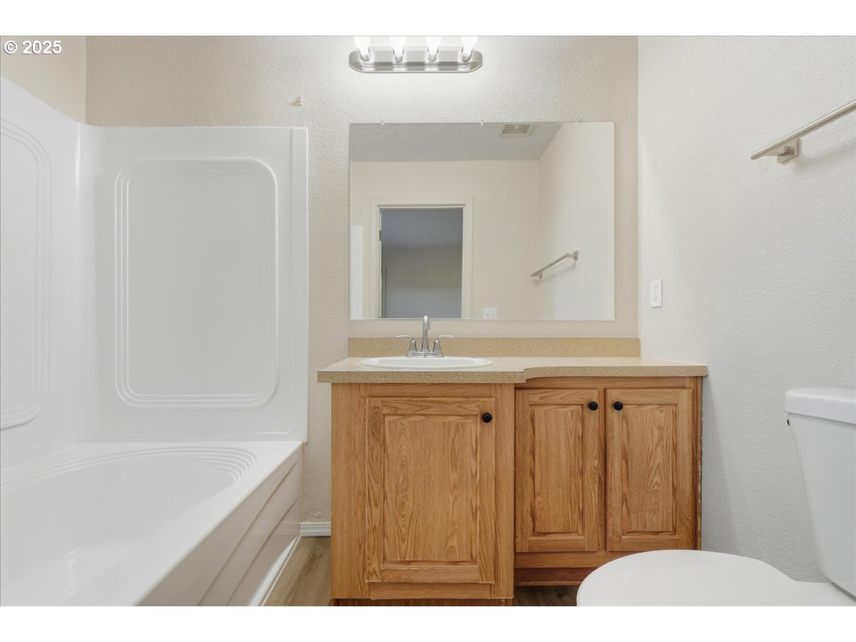300 Southwest 7th Avenue, Unit 901 Battle Ground, WA 98604 - Photo 14 of 31 a bathroom with a sink a mirror and a bathtub