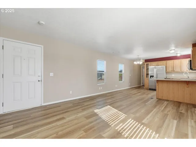 a view of an empty room and wooden floor