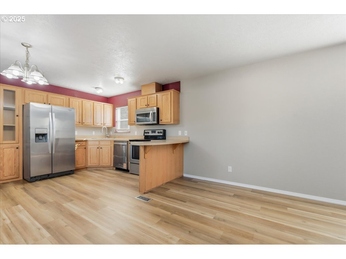 300 Southwest 7th Avenue, Unit 901 Battle Ground, WA 98604 - Photo 8 of 31 a kitchen with granite countertop a sink cabinets and stainless steel appliances